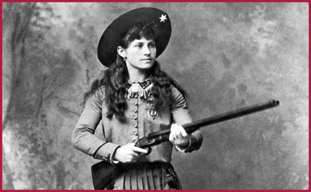 Annie Oakley holding a gun black and white image